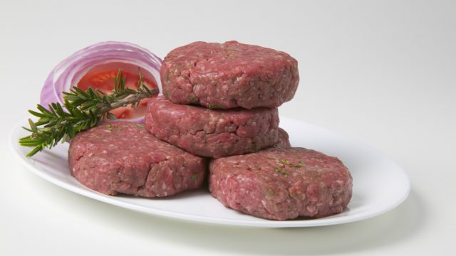 Raw hamburgers on a plate